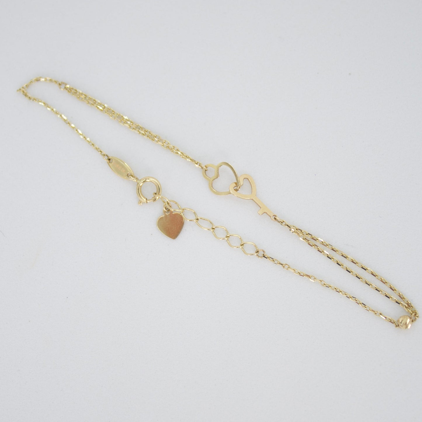 Pulsera corazón con llave en oro amarillo 14k.