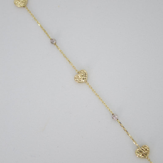 Pulsera corazones en oro combinado 14k.