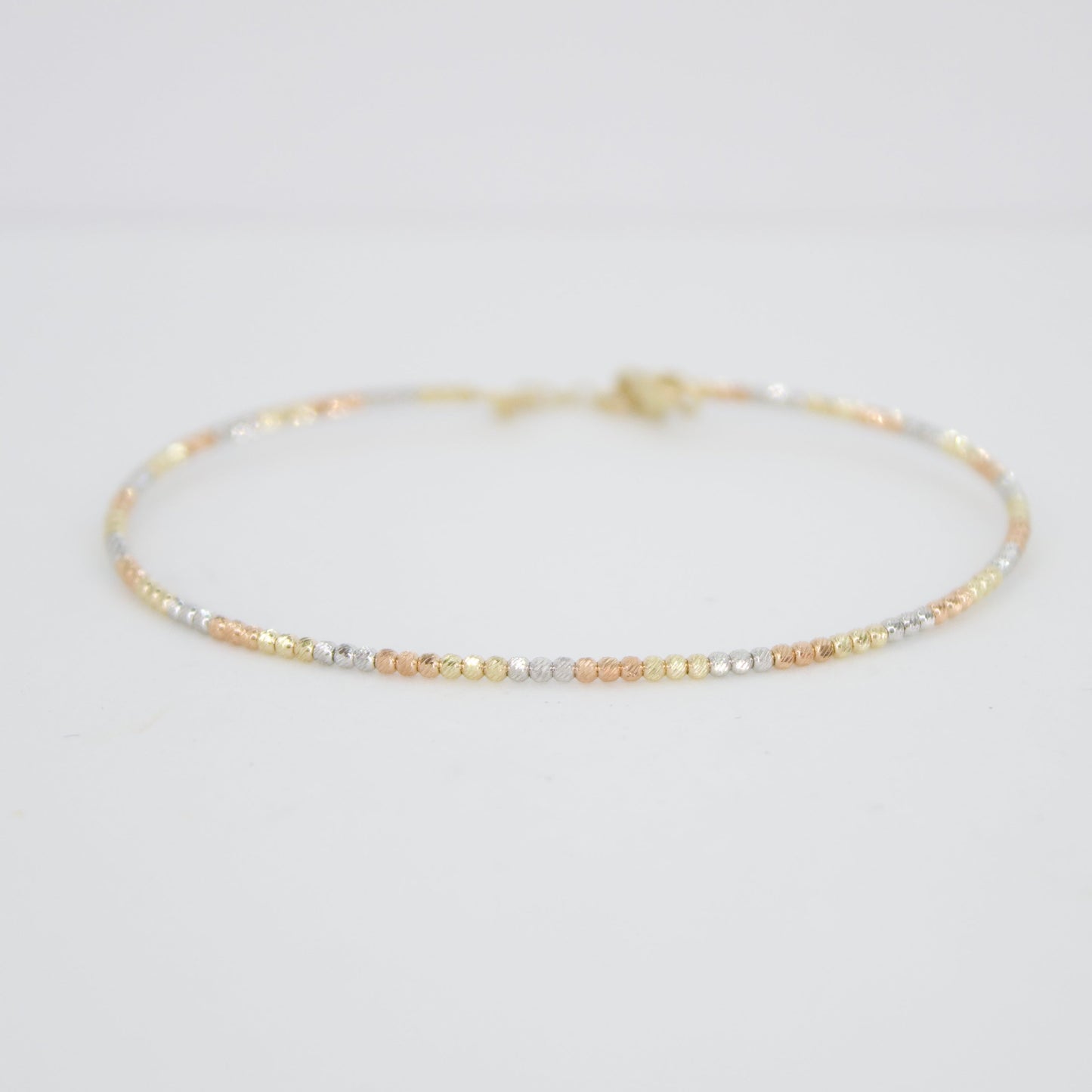 Pulsera rígida de bolitas en oro florentino 14k.