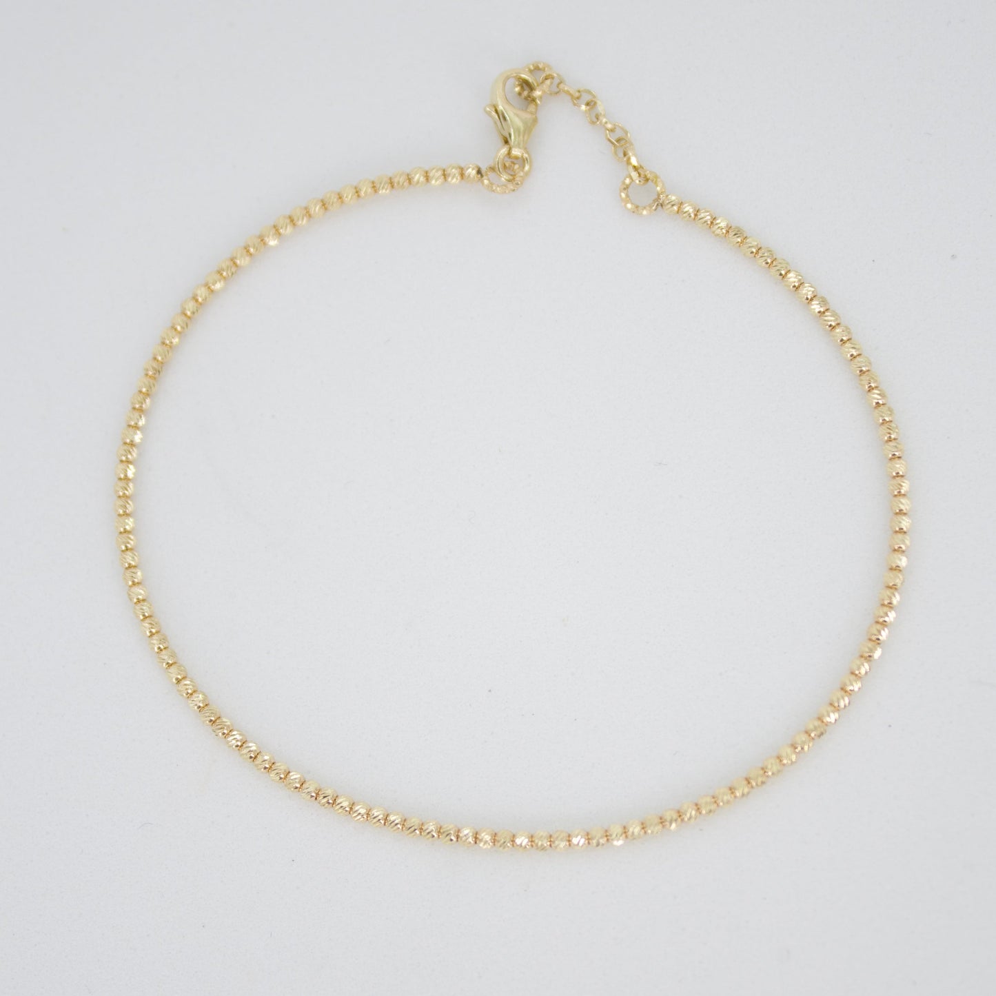 Pulsera rígida de bolitas en oro amarillo 14k.